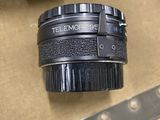 a camera lens sitting on top of a table next to a camera