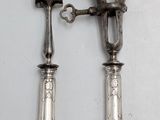 two forks and a knife on a white table