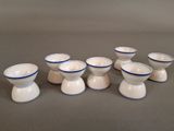 several small white and blue bowls and cups sitting on a table