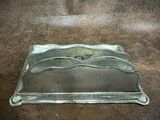 a metal tray that has a handle on it