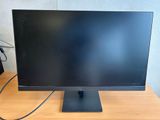 the monitor is sitting on the desk next to the keyboard