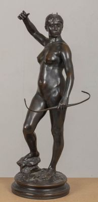 statue of a woman with a whip on a wooden table