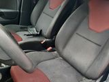 two seats in the back of a car that are red and black