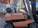 a forklift that is sitting on the back of a truck