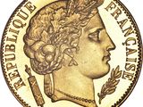 a close up of a gold coin with a woman ' s head on it