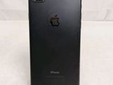 a close up of the back of a black iphone