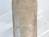 a vase that has a design on it in a glass case
