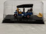 a miniature model of an old car in a glass case