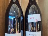 two bottles of wine sitting in a wooden box