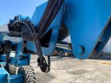 a close up of a blue machine with a large wheel