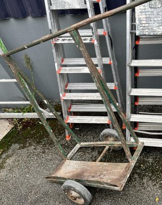 a dolly that is sitting in front of a building