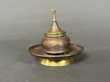 an antique brass incense burner with a dome on top of it