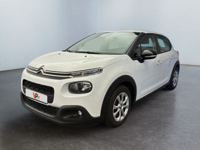 a white citrole car parked in a large room