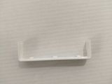a plastic shelf on the wall in the bathroom