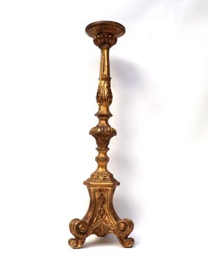 an image of a tall gold candle holder on a white background