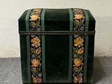 a small green box with a floral design on it