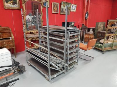 a room filled with lots of furniture and a red wall