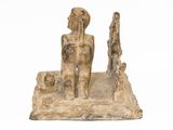 an image of a statue of a man and a woman sitting on a rock