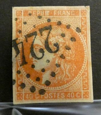 un timbre orange et noir sur lequel figure l'image d'une femme