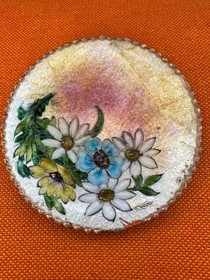 an image of a picture of a brooch with flowers painted on it