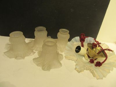 three glass vases and a bell on a table