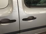 a white van that has some holes in the side of it
