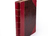 a red book that is sitting on a white surface
