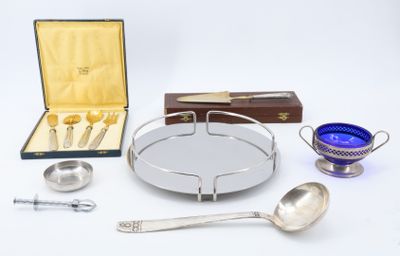a silver tray with spoons, spoons, and other items on it