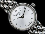 a close up of a wrist watch with a chain around it