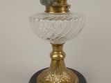 a gold and glass vase on a black base
