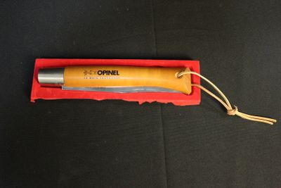 a knife in a red box on a black surface