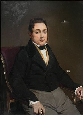 portrait of a man in a black jacket and yellow tie sitting in a red chair