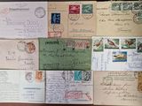many different types of letters and envelopes on the table