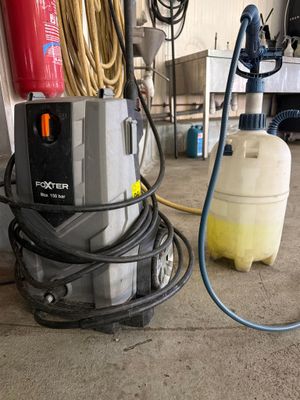 a machine that is sitting on the floor next to a tank