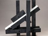 a black and white sculpture made out of wooden blocks