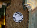 a sticker on the door handle of a wooden door