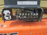 a close up of the engine of an orange tractor
