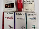 several books are sitting on a table next to a cup of coffee