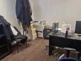 a room with a desk, chair, and a computer monitor