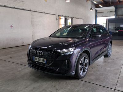 the audi qx is parked in a garage with its lights on