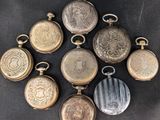 six antique pocket watches are arranged in a circle on a black background