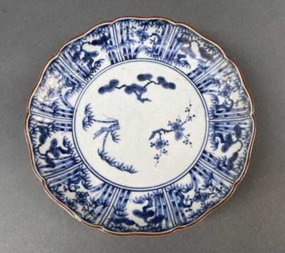 a blue and white plate with a bird on it