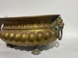 brass footed urn with lion head handles and handles
