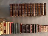 a lot of books that are on a shelf