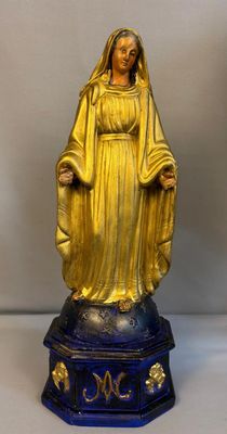 gold statue of the virgin of guadalupe on a blue base