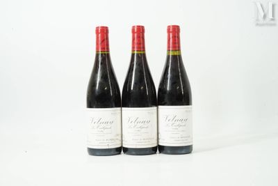 three bottles of wine sitting on top of a white table