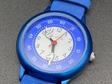 a close up of a blue wrist watch on a table