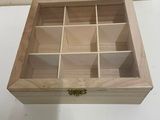 a small wooden box with compartments on a table