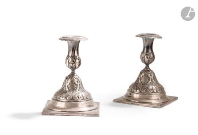 pair of antique silver candlesticks on stand on white background