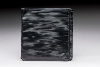 an image of a black wallet sitting on top of a table
